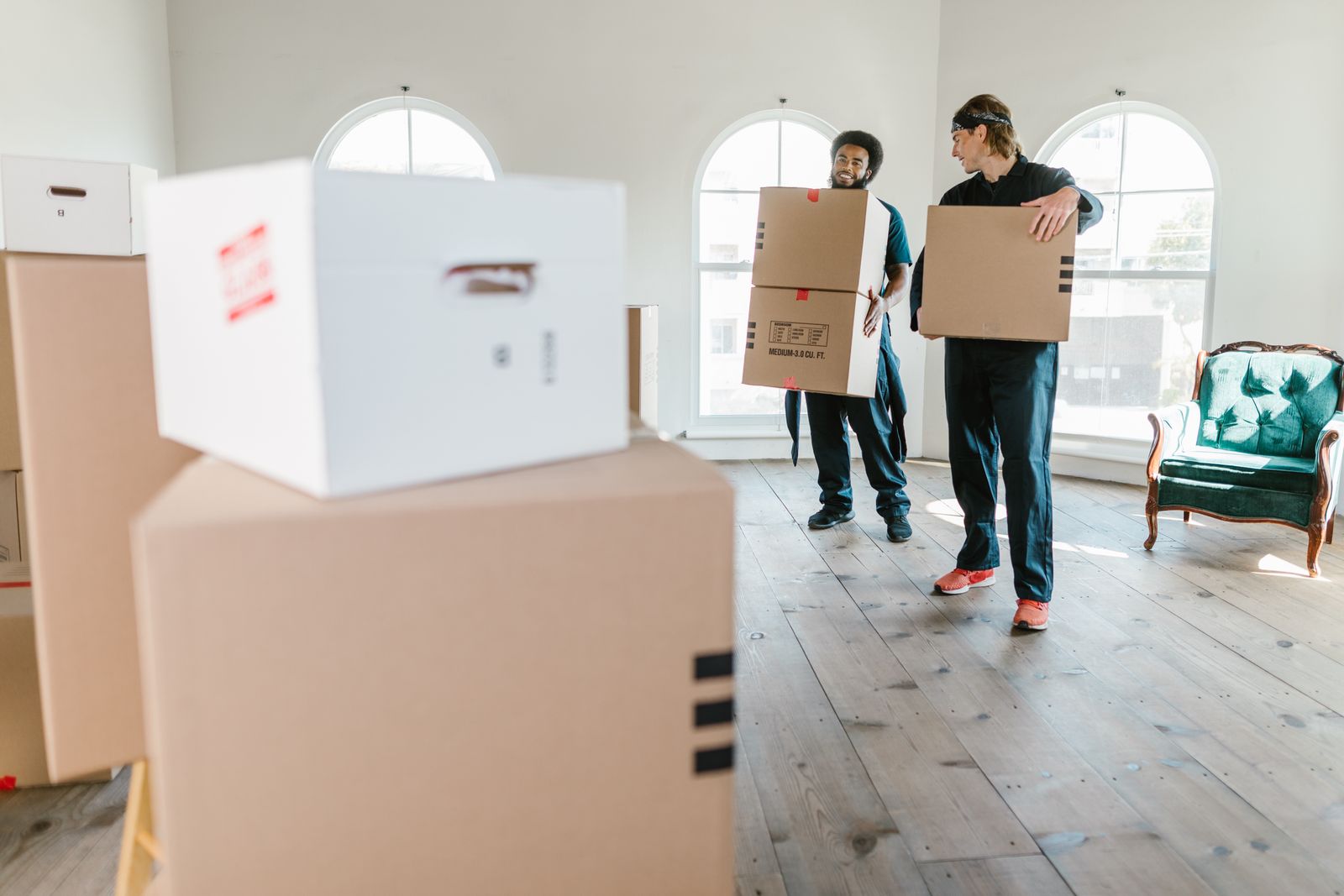 Acme Removals team carefully carrying furniture into a home